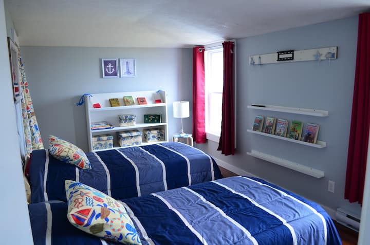 Bedroom 3 - Nautical-themed room with twin beds, children's books, and toys. Perfect for the kids!