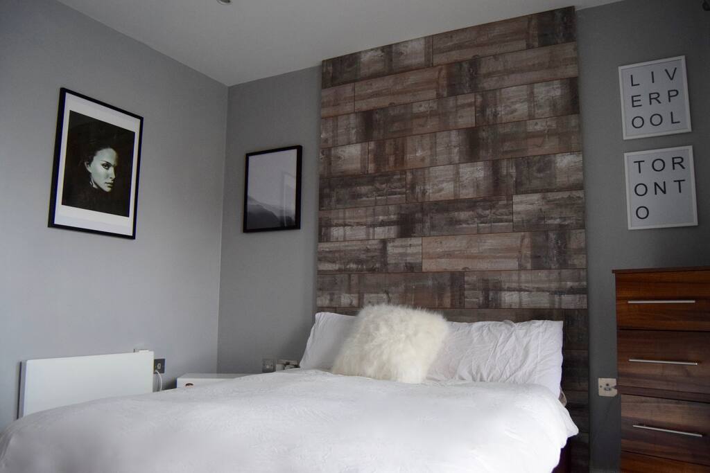 Cozy and warm bedroom with large ceiling to floor windows overlooking the dock