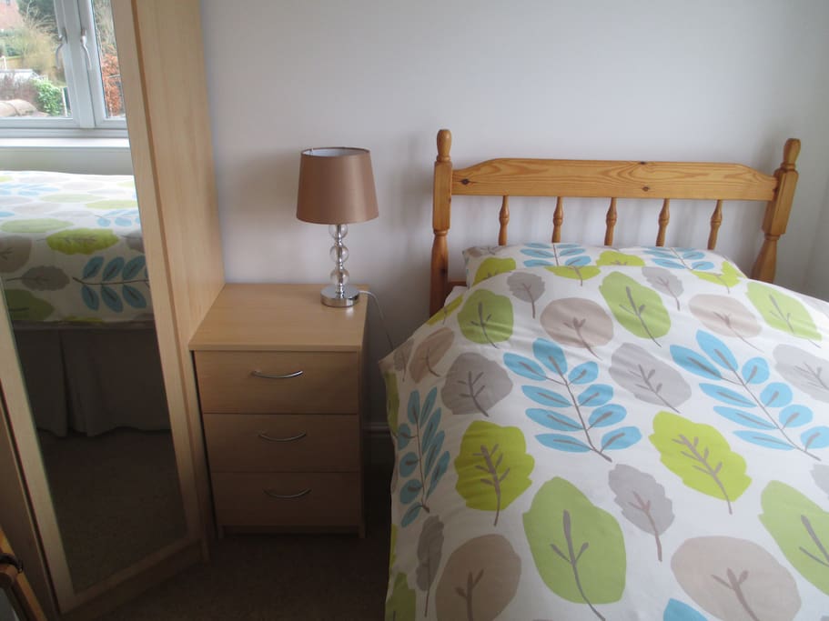 Room has a wardrobe and bedside storage