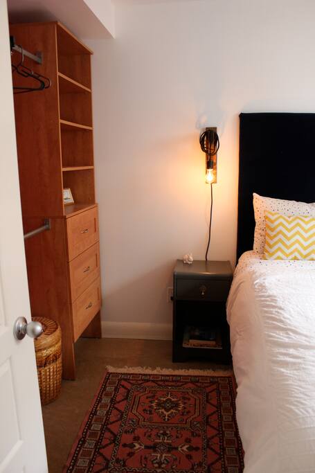 Queen size bed complete with accessible bedside lights, bedside tables and storage.