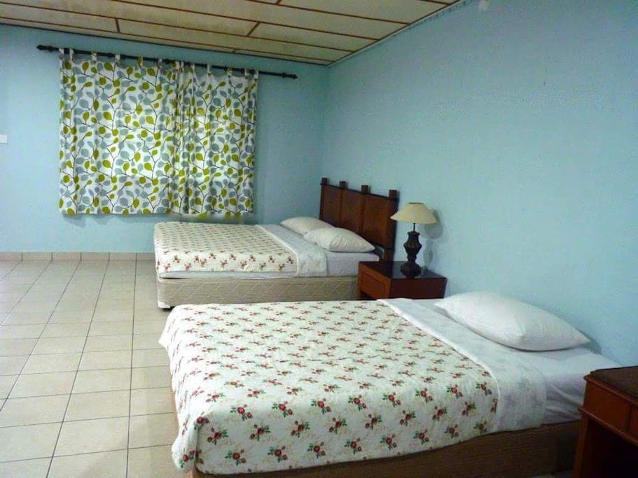 Deluxe room with 1 king bed and 1 single bed with attached bathroom