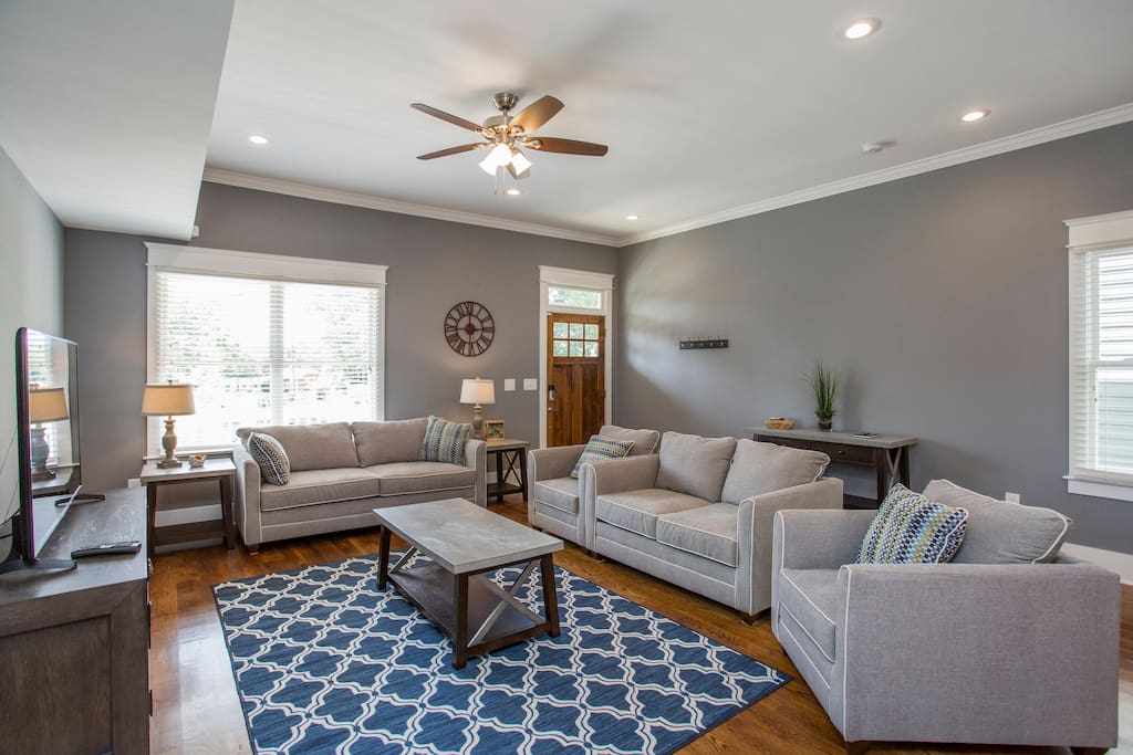 The living room and the front door. The couch pulls out into a queen bed.