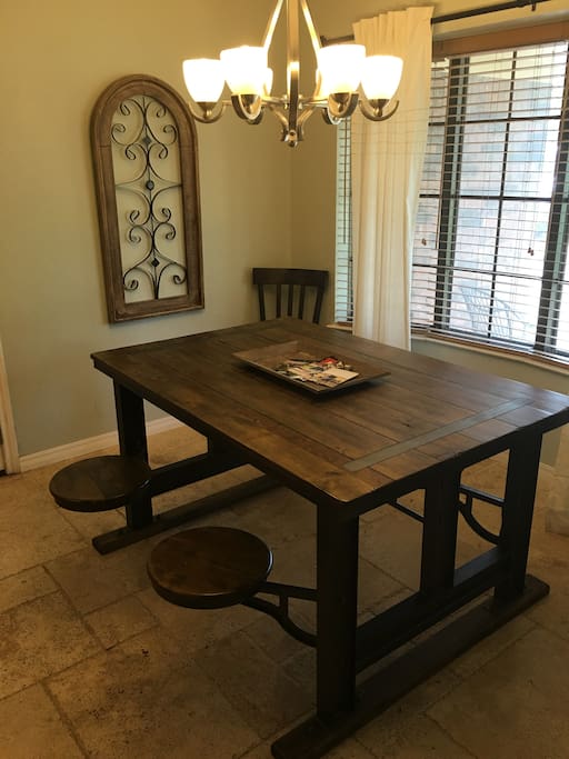 Modern table with attached, fun swinging stools and additional seating for six.