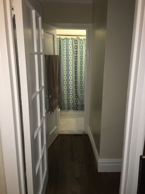 Hallway to Washroom with full Bathtub