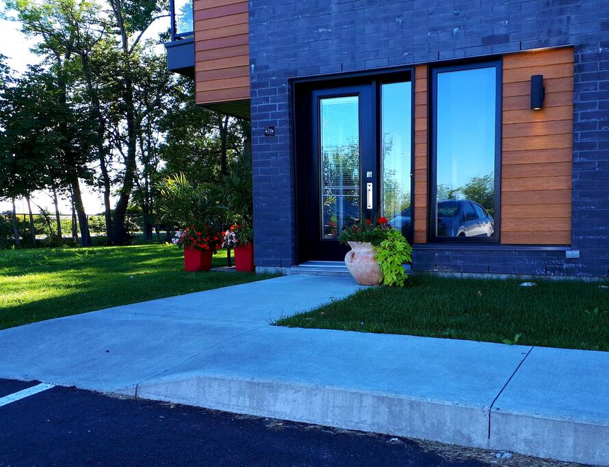Parking just in front of door ! Ground level so no stairs to go up. Door right in front of parking.This new condo building has 3 floors.
5 steps from your car to condo door.