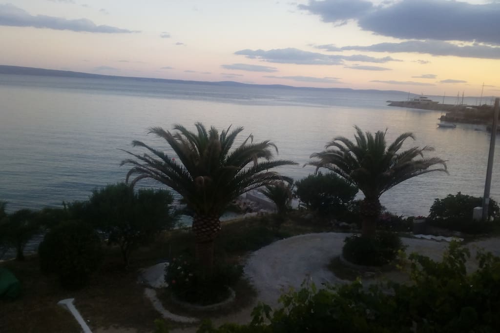 The view from the balcony to the private beach and parking lot