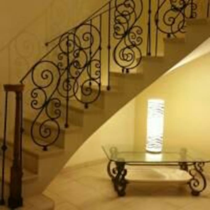 Staircase leads to the two bedrooms and the bathroom.