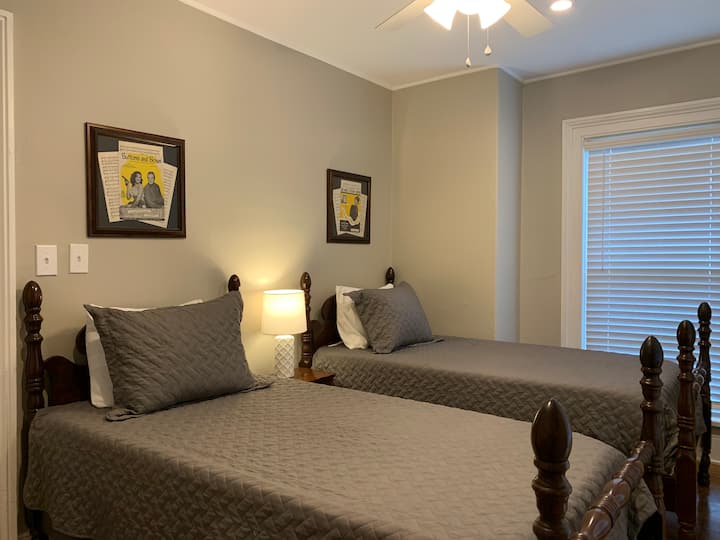 The Music Room is our coziest bedroom and features two beautiful walnut twin beds with vintage sheet music framed above the headboards.
