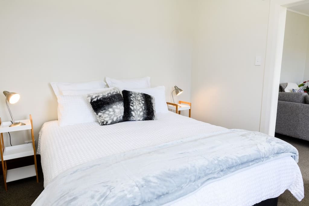 King size bed with quality linen and plush overlay.
