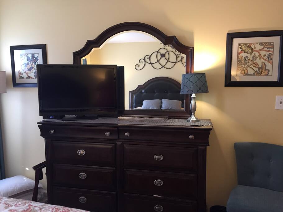 Flatscreen TV with remote control ample dresser storage