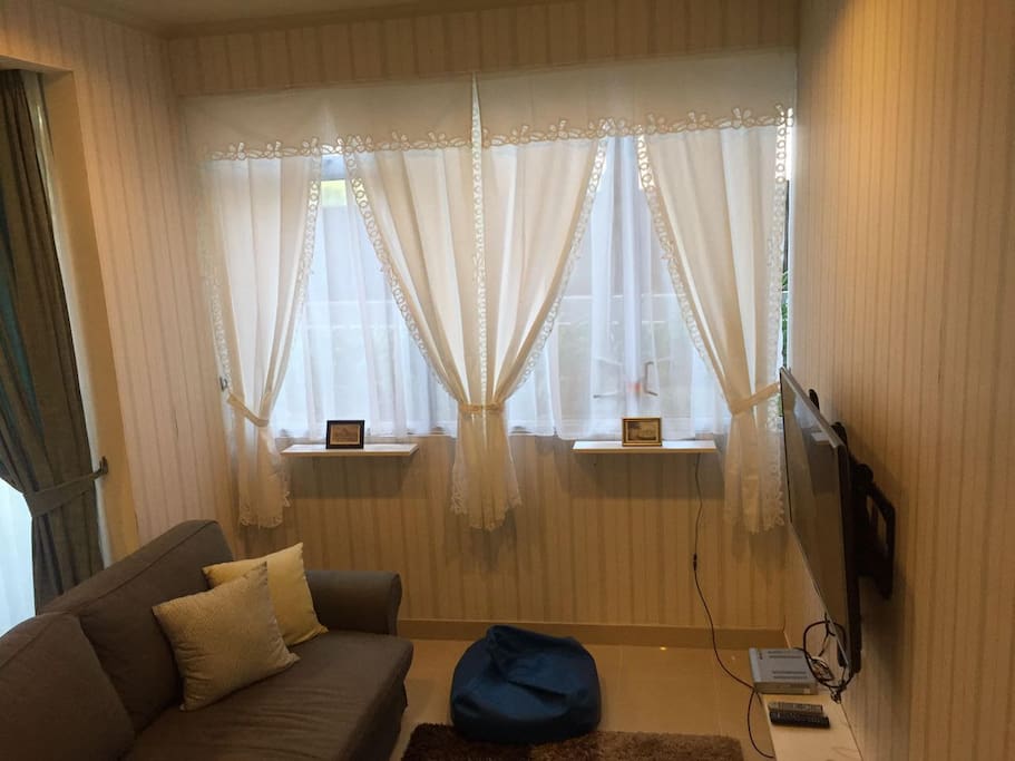 Big windows with a sweet touch of the curtain