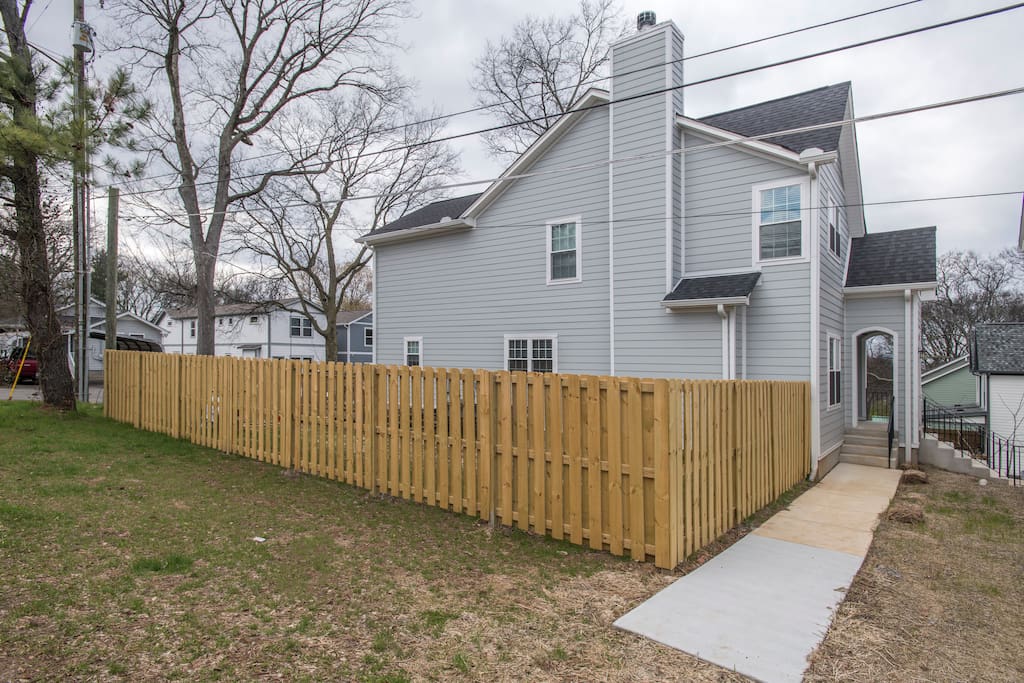 Side of house with fenced in yard