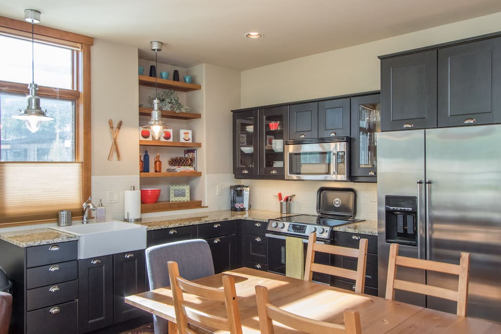 Kitchen includes full-size stovetop, oven, fridge, microwave, and dishwasher.