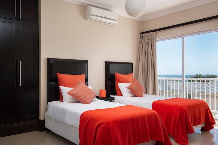 Twin beds with view to sea.