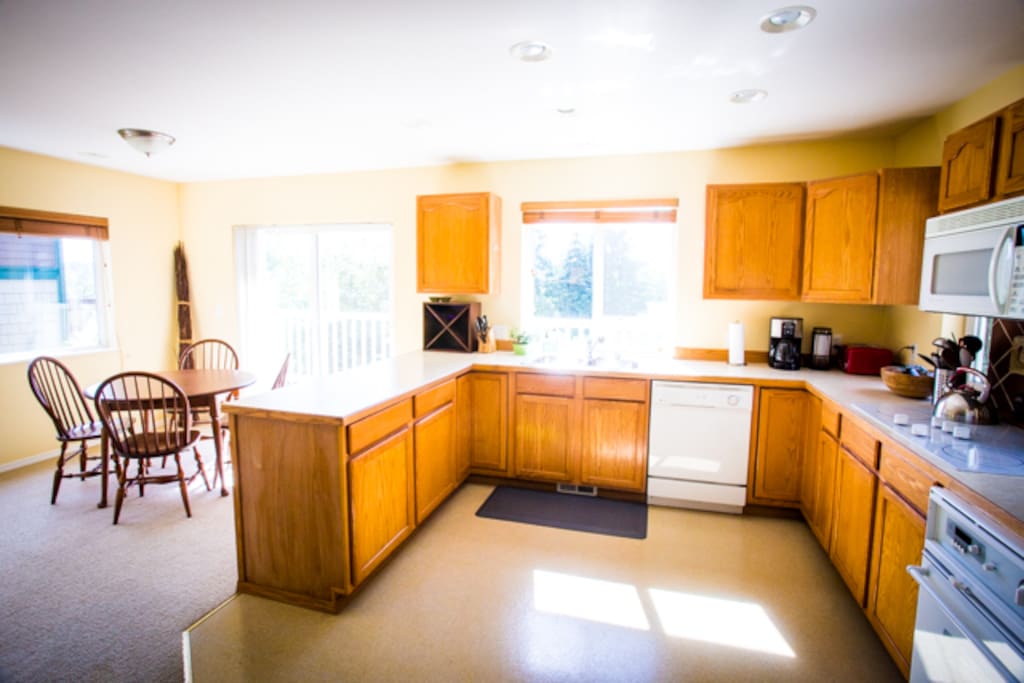 Kitchen - with sunlit dining area. Opens up to a private balcony.