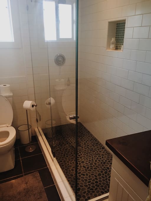 Remodeled bathroom with rock floor for the best, most relaxing showers ever!
