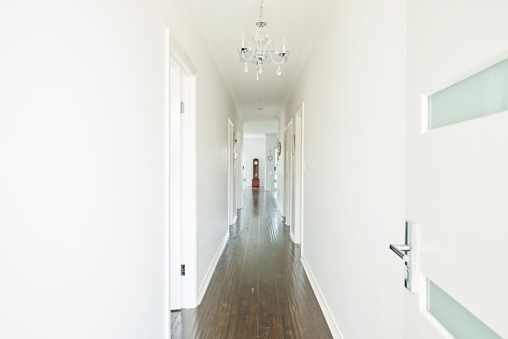 Passageway from front door through to bedrooms and kitchen and living area at the end