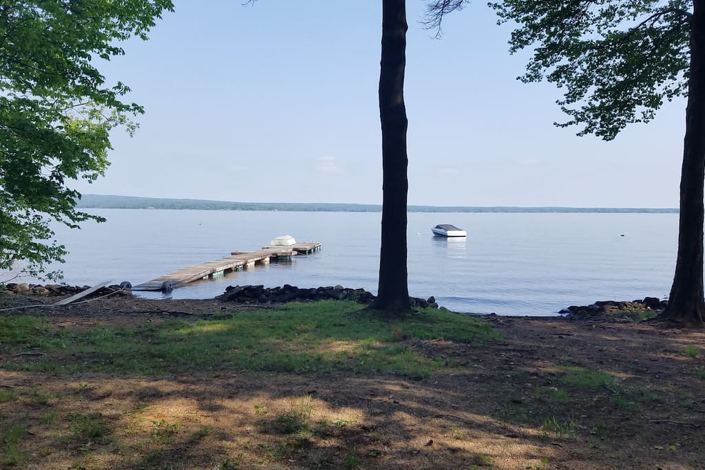 View of the lake and our dock from the beach. Dock is 70' long and can hold a 22' boat.