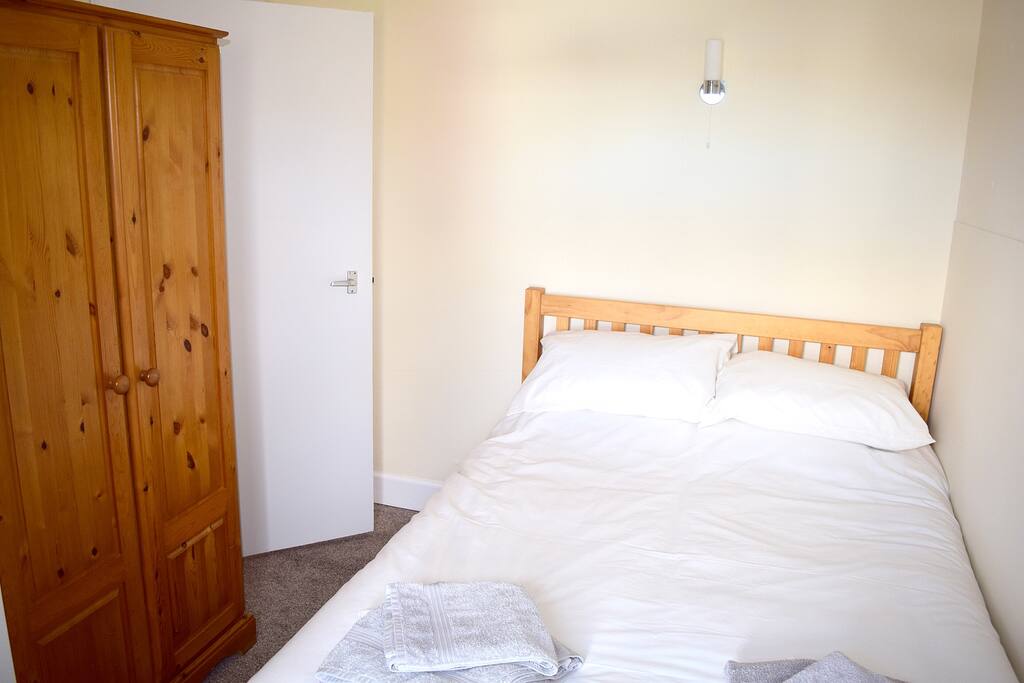 Bedroom 1 is a double room with wardrobe and set of drawers for storage.