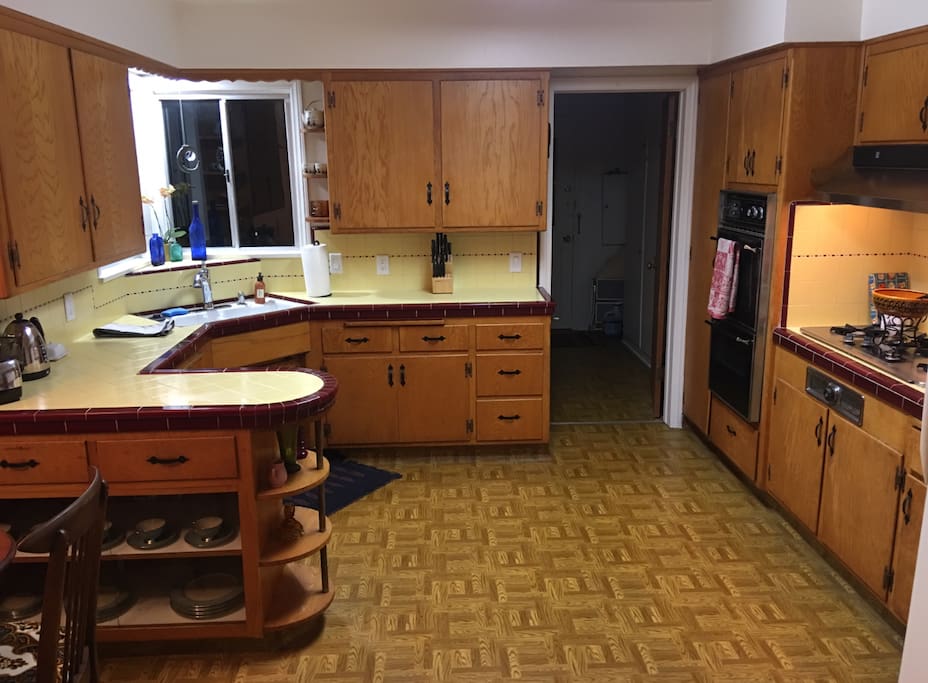 The kitchen is a blend of vintage and somewhat modern. Fully stocked with cutlery.