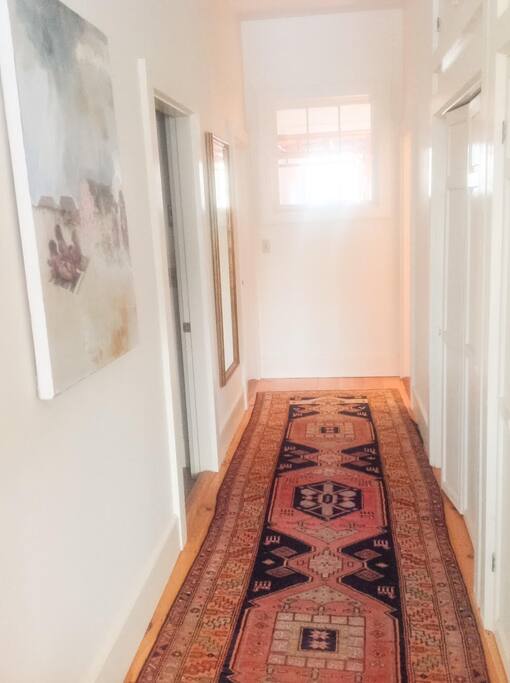 Hallway - Sunny path to two bedrooms, closets and bathroom