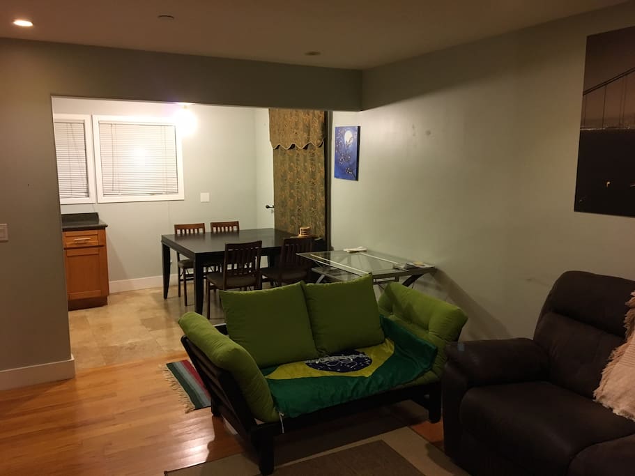 Specious living room with a sofabed, couch and dinning table for 4