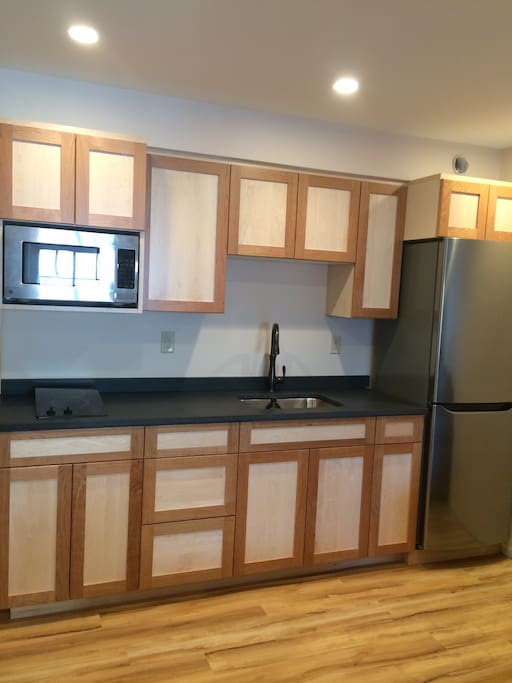 Kitchen with stove, fridge, dishes