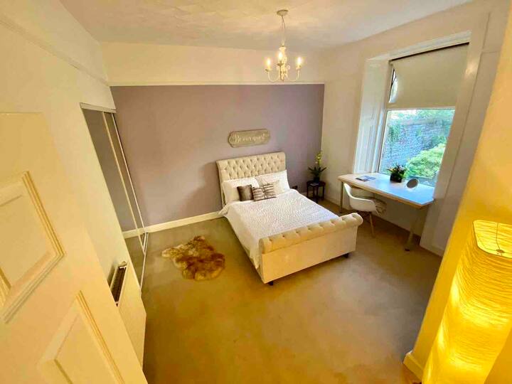 Our super peaceful bedroom which features a walk-in wardrobe and desk/workstation, overlooking our private garden.  Shown here set up for two, but also available for 3 on request.