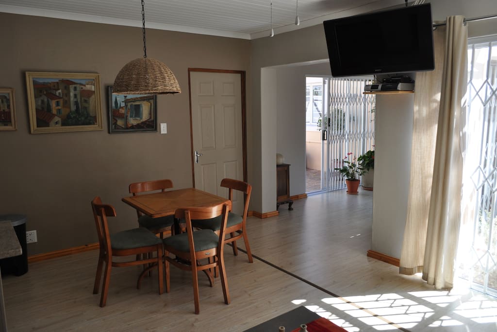Lounge, kitchen and dining room with flat screen TV. shared with one other guest