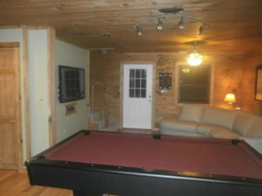 Large game room area for hours of fun & excitement. Pool table coverts into ping pong table.