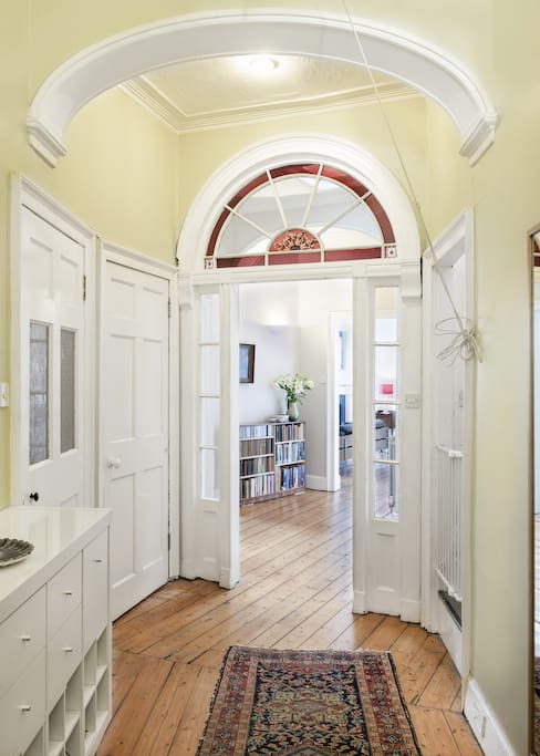 A large entrance hall leads onto a central hall from which there is access to the kitchen diner, living room, and bedrooms.