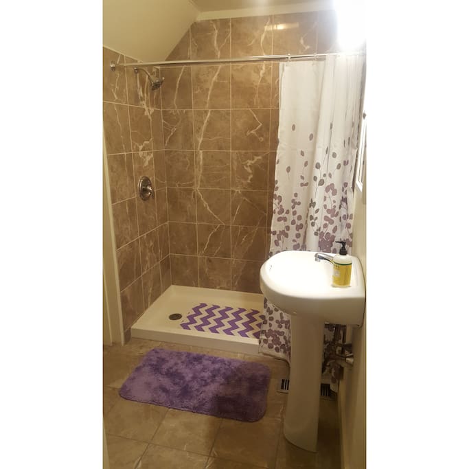 Tiled shower in the private, attached bathroom.