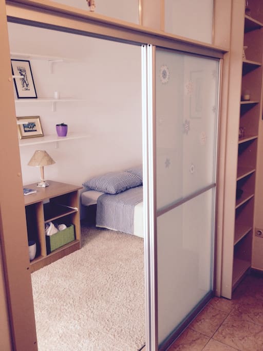 Sliding door separating bedroom and small living area