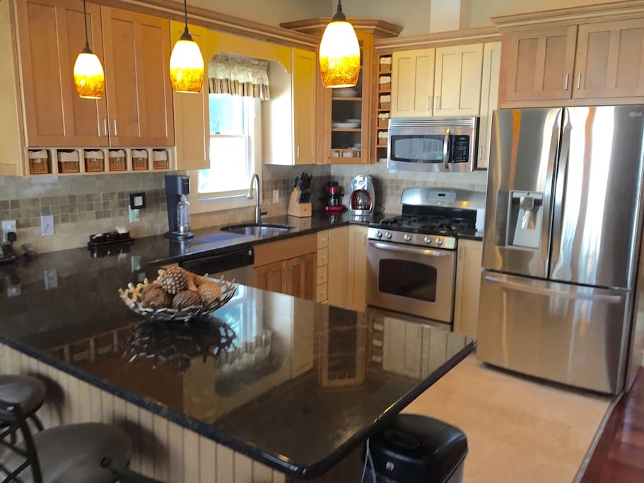Gourmet kitchen with stainless steel appliances including a wine fridge.