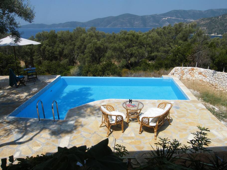 View of main pool terrace at midday showing a mixture of sun and shade