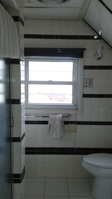 Clean, modern bathroom with window.