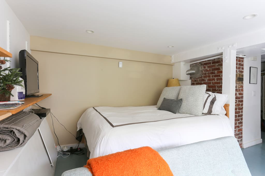 Comfortable queen-sized bed with high thread count sheets.