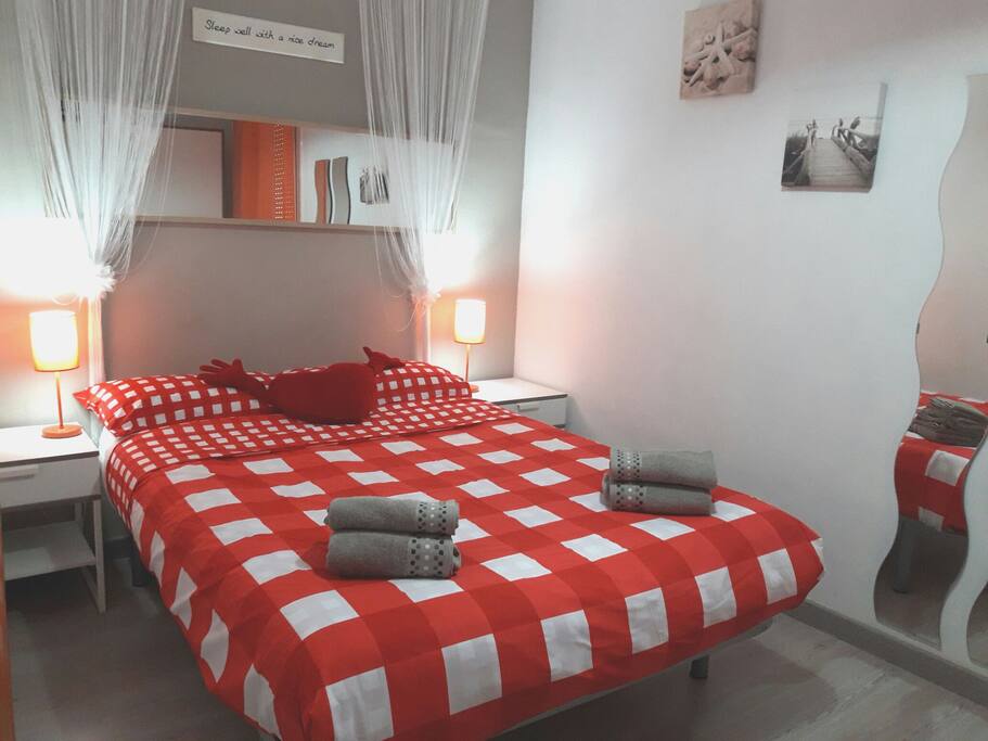 A first double bedroom with a balcony.