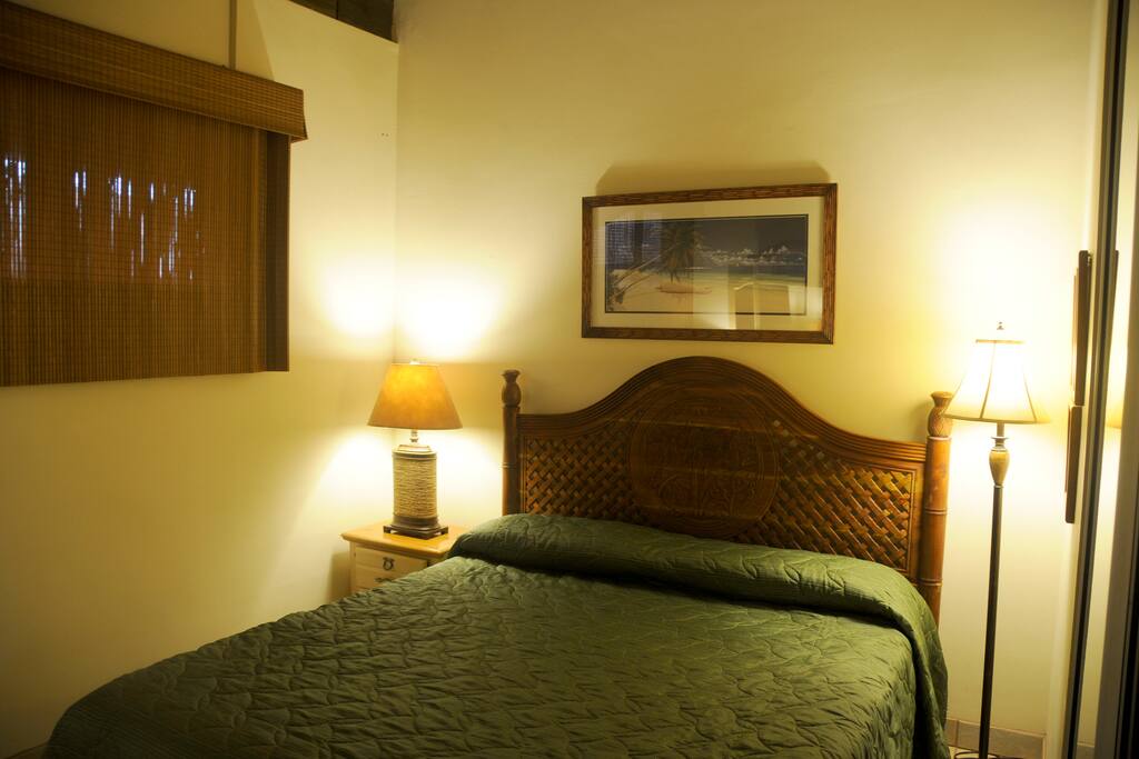Beautiful hand carved headboard and bamboo shades.