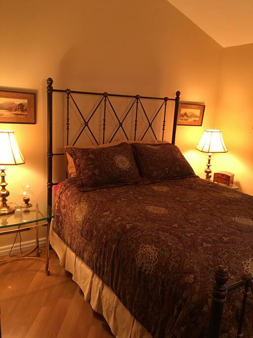 Queen bedroom is cozy and near the shared bath.