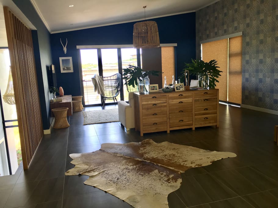 Staircase from parking leads up to living area with laptop friendly workspace