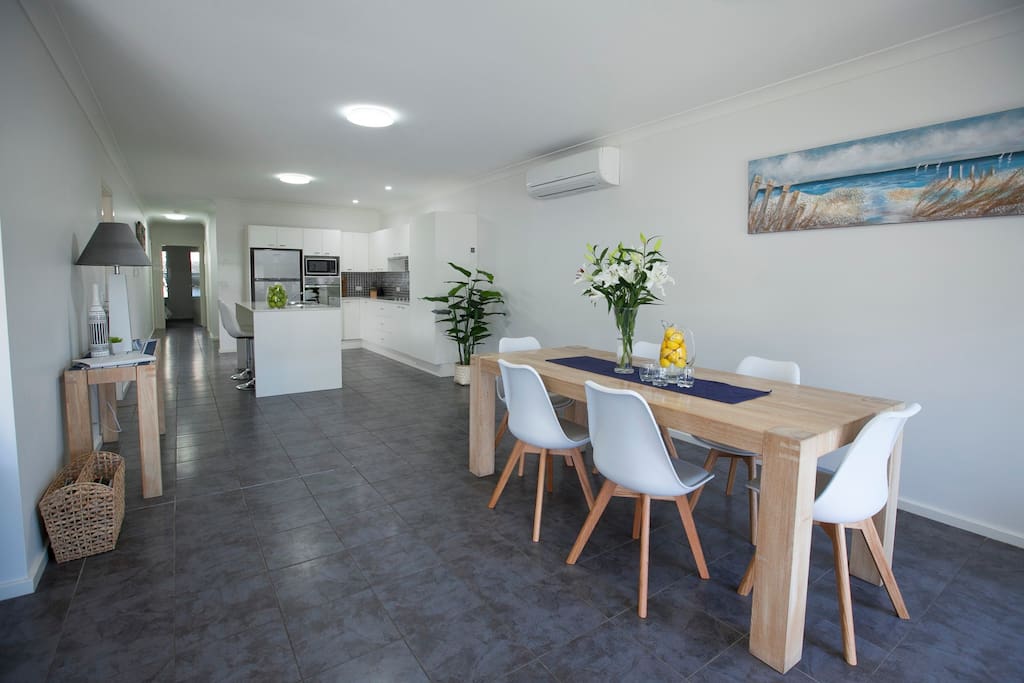 Dining looking to Kitchen and down to bedrooms