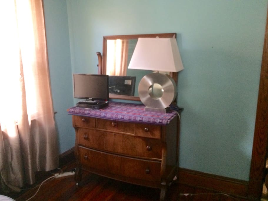 Room has small flatscreen tv/cable, dresser, chair, table, closet, etc