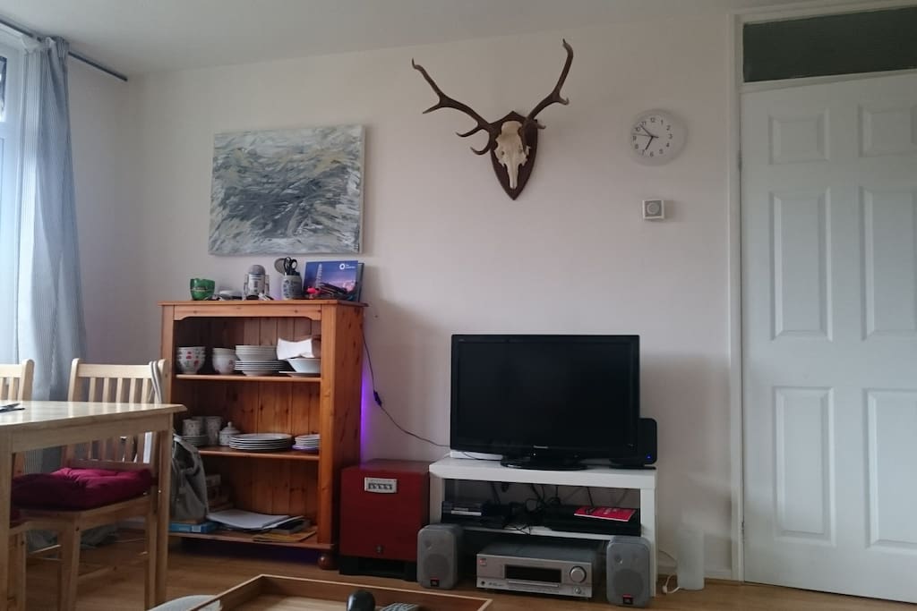 There is also a dining table with 4 chairs within the living room