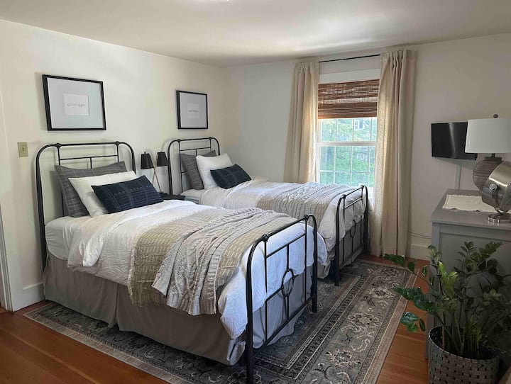 Upstairs bedroom, 2 twin beds with a sitting chair and a small table and chair setup