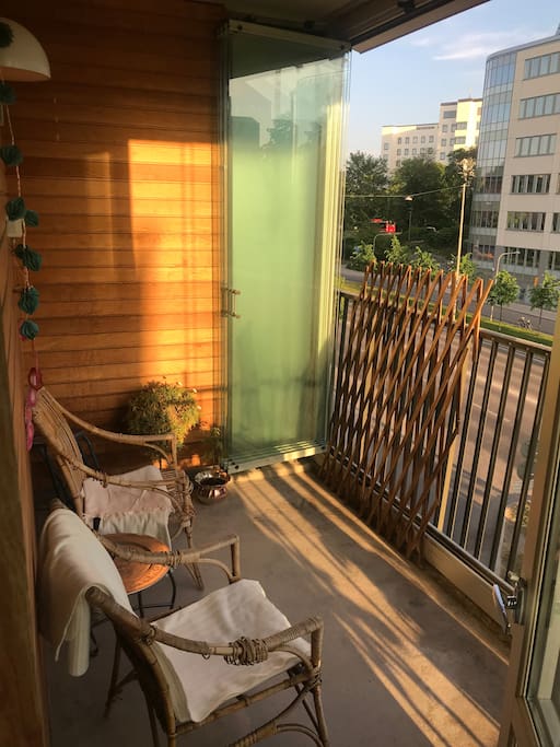 Balcony with flowers, tomato plants and blankets for the cooler evenings.