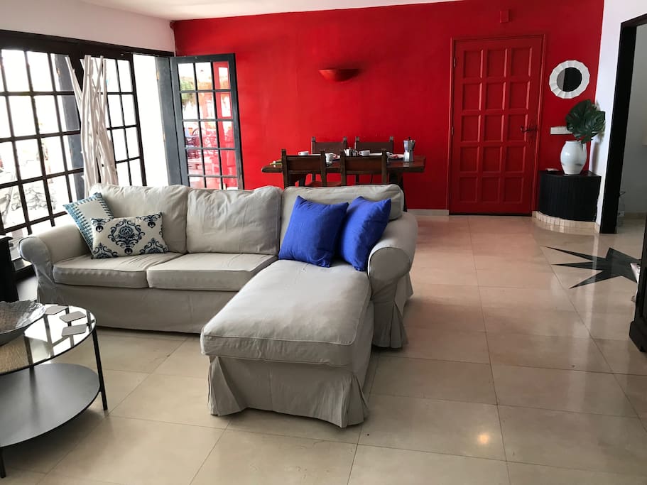 Open plan living/dining/kitchen with tv and access to garden/terrace.