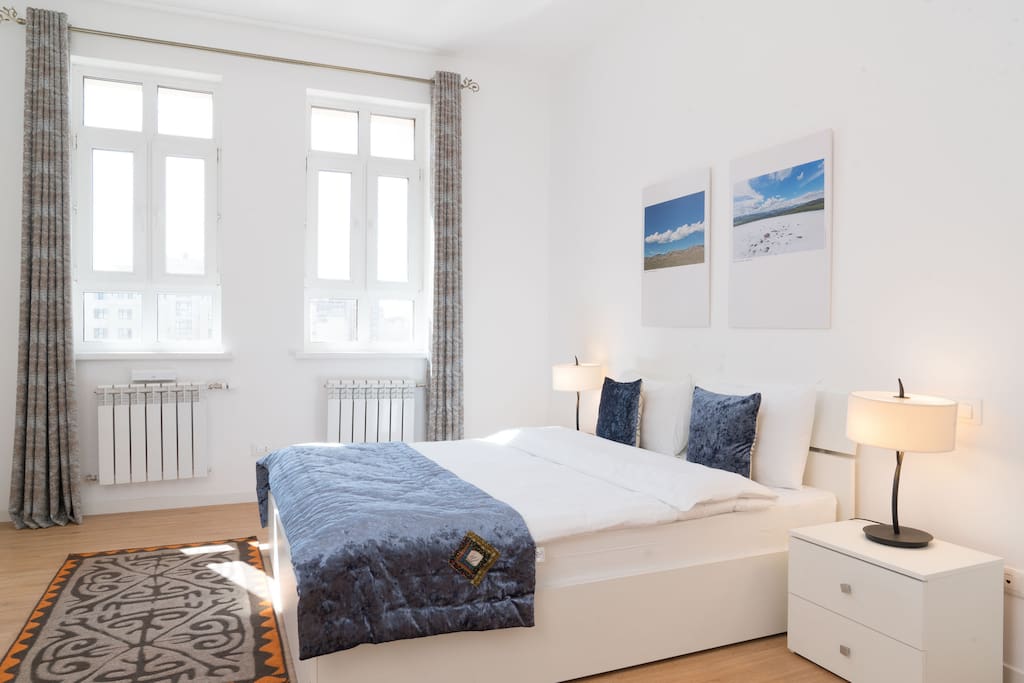 comfortable bedroom, with white linens, furniture from Italy, orthopedic mattress, decor in ethno style