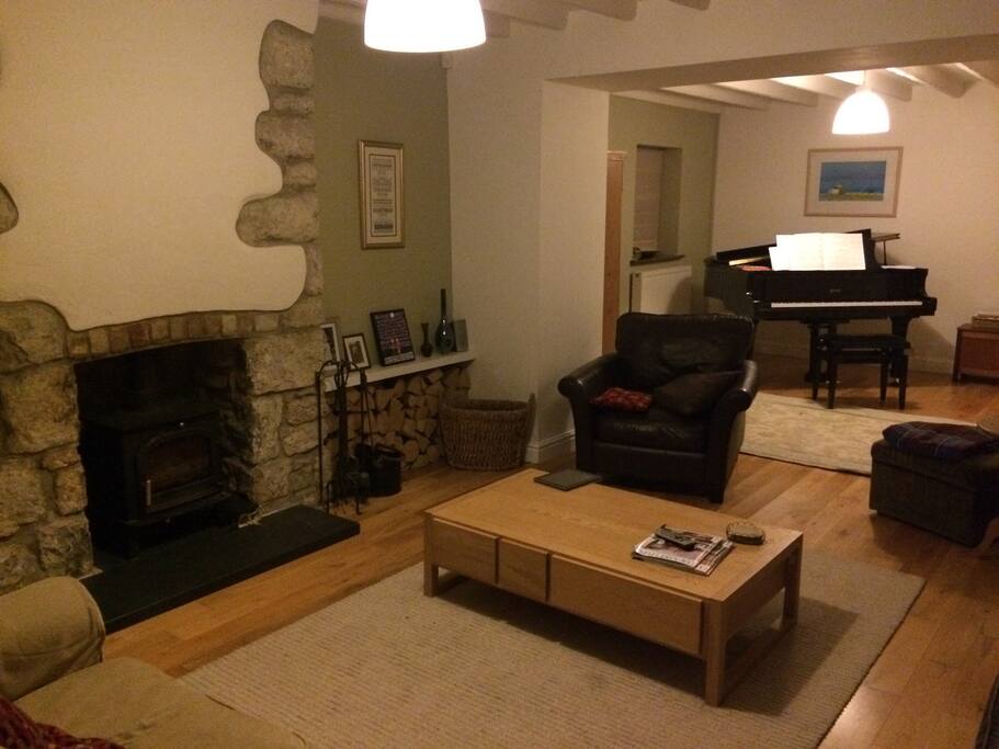 lounge with log burner and piano