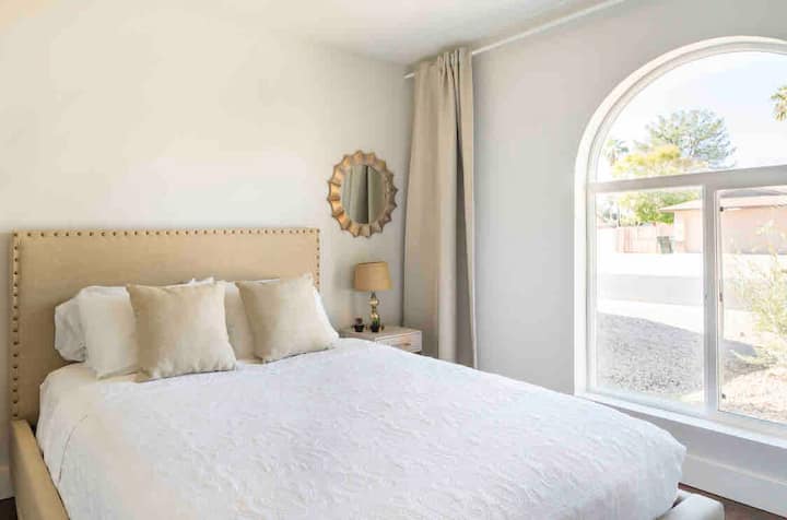 Bedroom 3: Queen bed. Bright room that has a view of Large Saguaro Cactus  and Olive tree.  